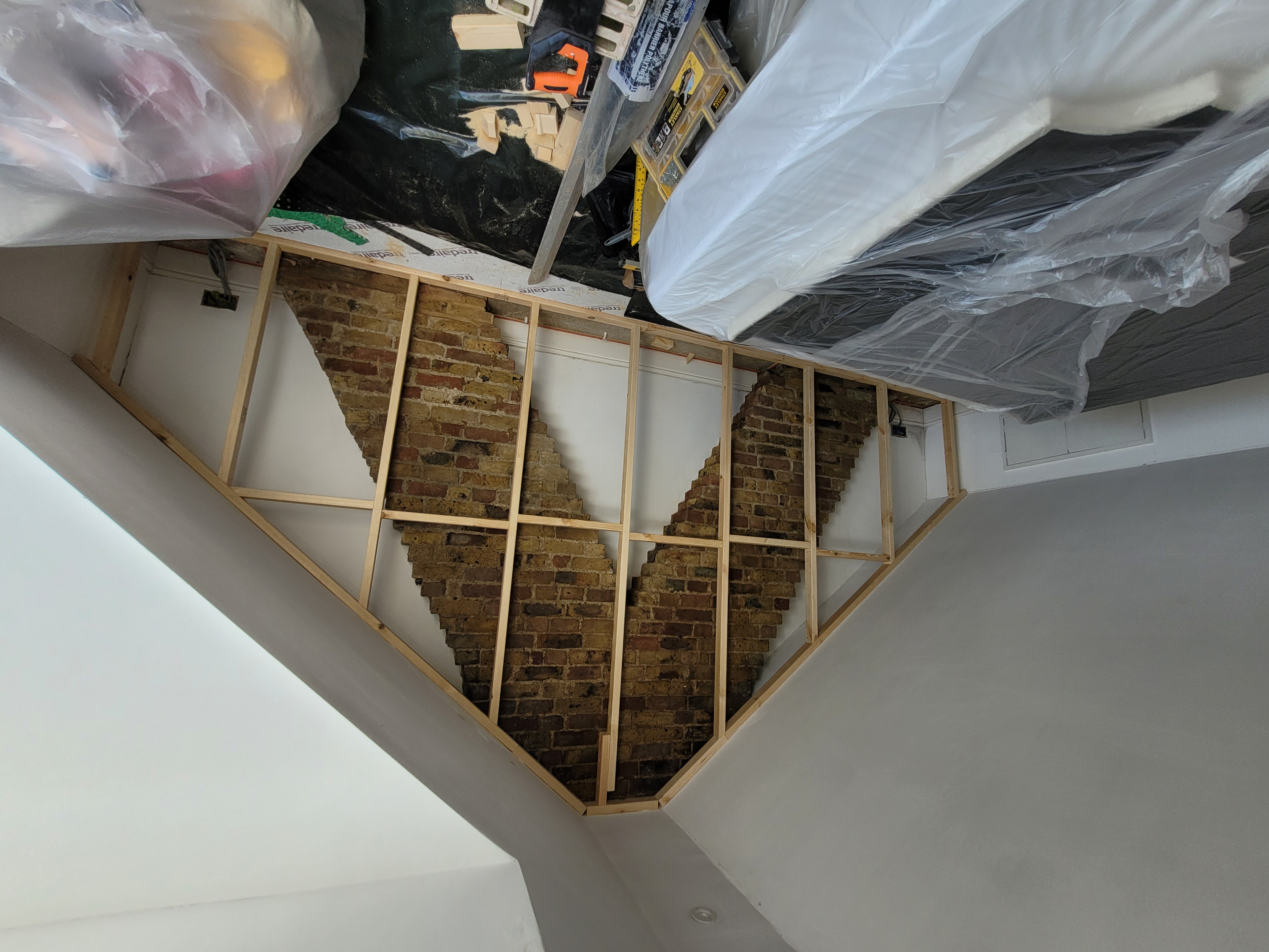 The attic wall now being shut in by making a structure of wood to then prepare for the next step, it now covers the arrow